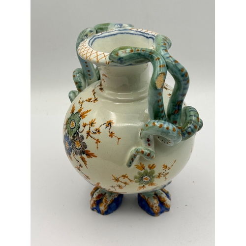 39 - A Polychrome Glazed Earthenware Vase with Serpent Handles and Claw Feet