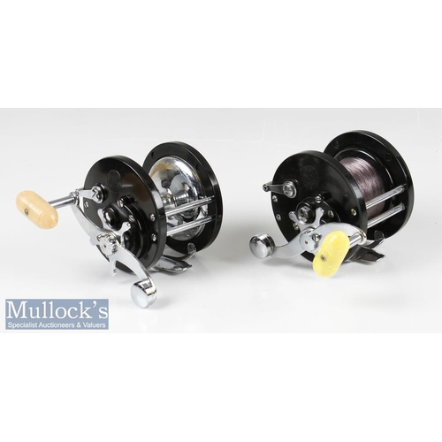 111 - Penn Demar 285 Multiplier Reels (2) both with black bodies having chromed fittings, one with yellow ... 