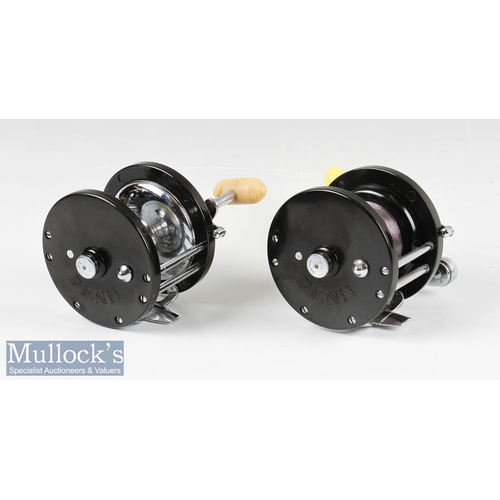 111 - Penn Demar 285 Multiplier Reels (2) both with black bodies having chromed fittings, one with yellow ... 
