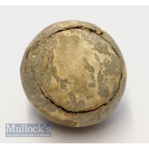 604 - An unnamed Featherie golf ball  retaining some of the original paint finish and the remains of the ... 