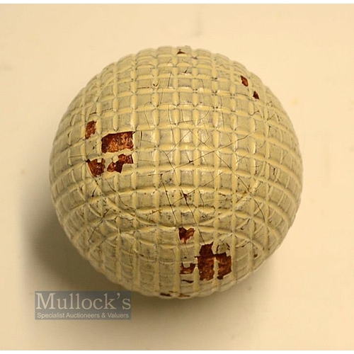 148 - An original and unused moulded mesh small guttie golf ball - with all the original white paint - vir... 