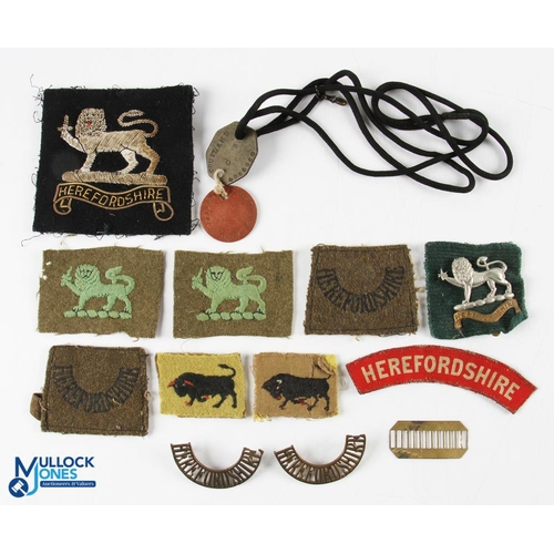 695 - WWII Herefordshire KSLI Cloth Badges Titles, Blazer Badges collection, and dog tags for Pte Coupland... 