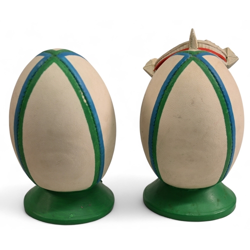 94 - Pair of Large Heavy Ceramic Welsh Rugby Ball shaped figures (2): One with model of the Millennium/Pr... 