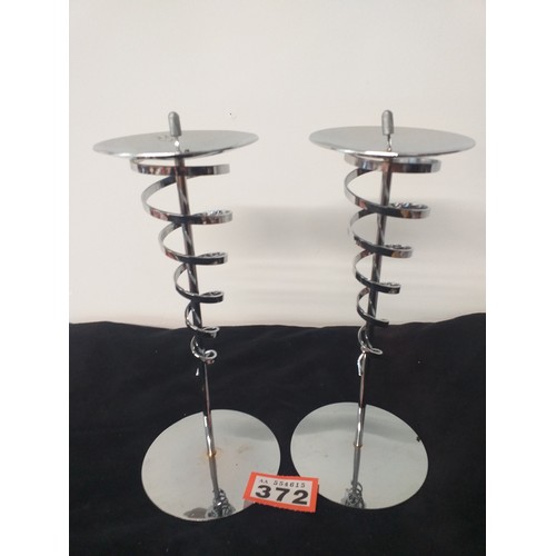 372 - Two stainless steel candle holder matching