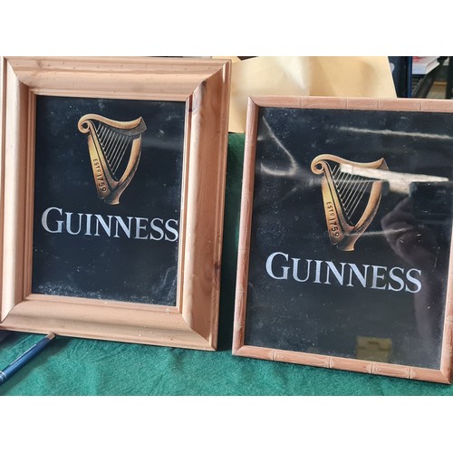 Pair of framed guinness prints