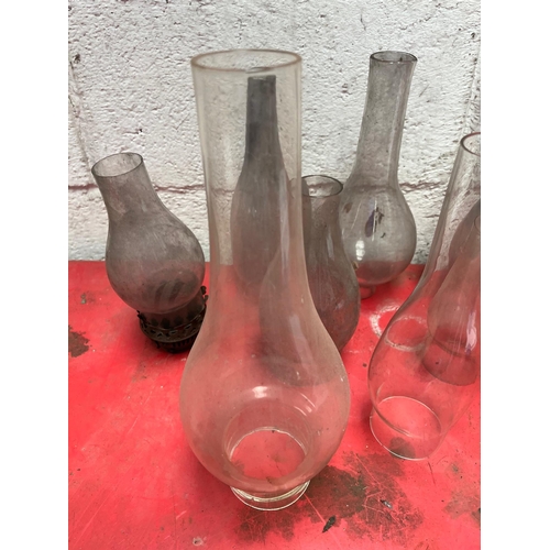 101 - Collection of oil lamp glass chimneys.