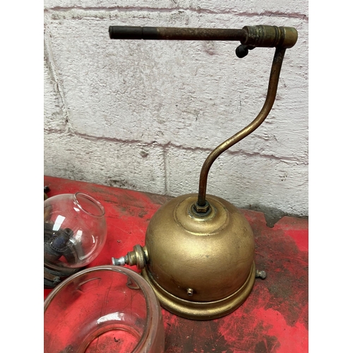 109 - Two wall mounted Tilley lamps with various shades etc