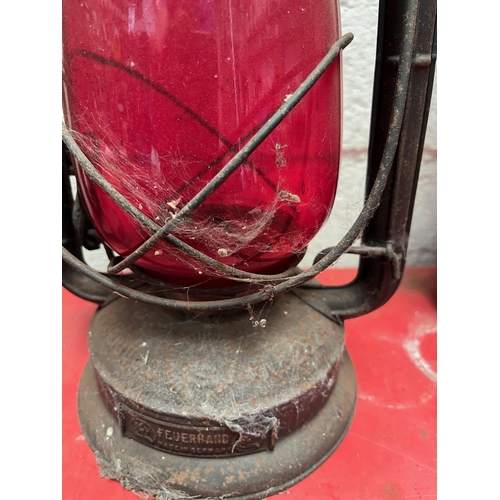 118 - Three Antique oil lamps with ruby shades.