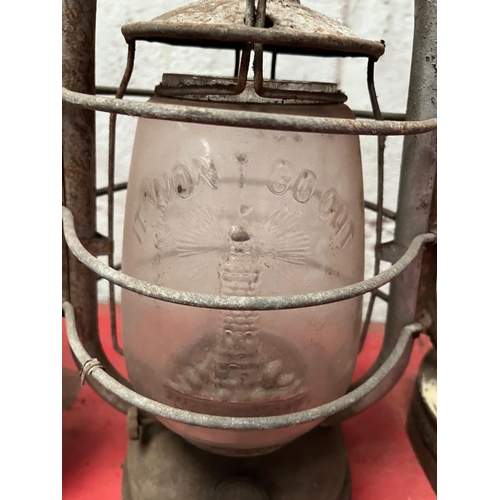 19 - Four Antique Tilley lamps, clear and ruby glass.