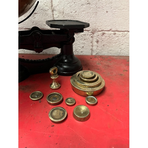 20 - Cast iron weighing scales with brass dish and weights.