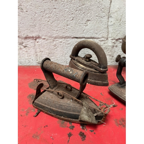 24 - Antique cast iron and metal irons.