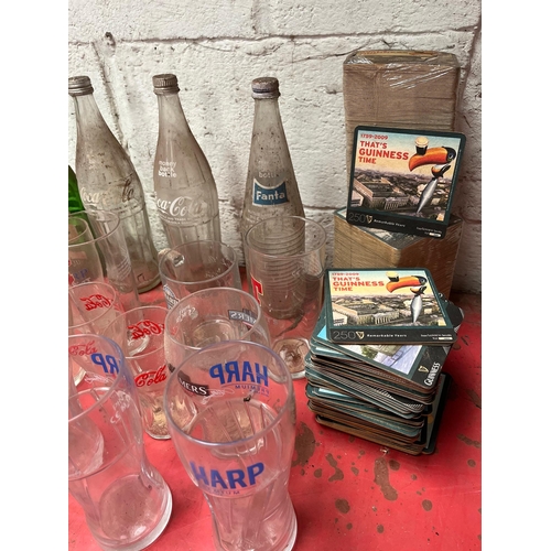 39 - Vintage mineral bottles, glasses, and beer mats.