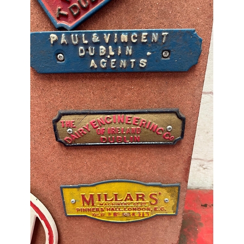 97 - Collection of mounted metal name plates.