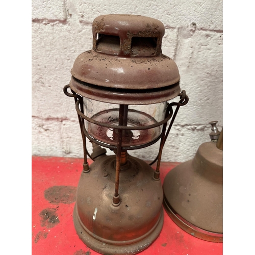 59 - Antique brass Tilley lamps.