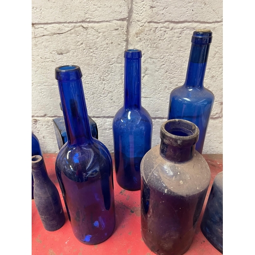 68 - Blue glass bottles of various shapes.