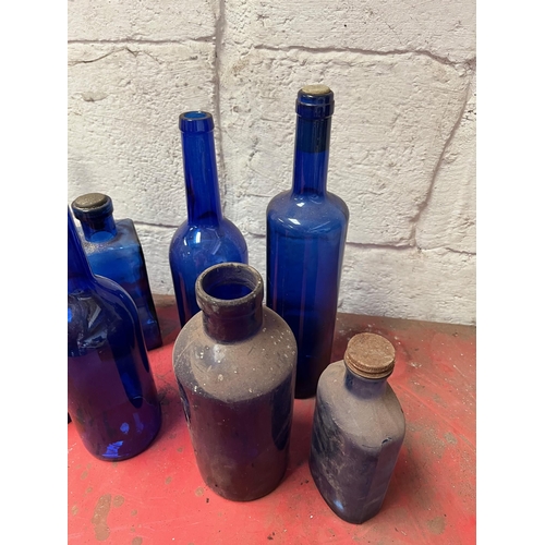 68 - Blue glass bottles of various shapes.