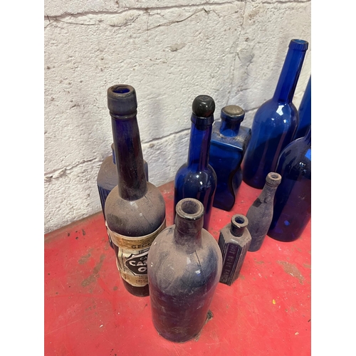 68 - Blue glass bottles of various shapes.