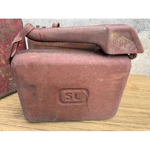 13 - Three Vintage Jerry cans. {Largest W 33 cm H 40 cm H x D 11 cm}