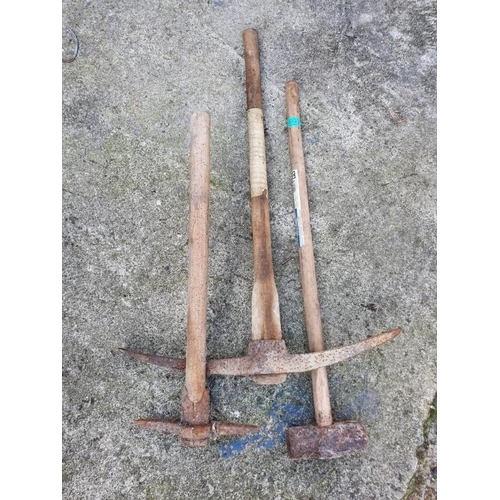 143 - Two pick axes and a lump hammer.