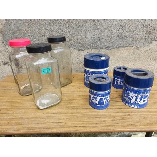 157 - Three sweet jars and four willow pattern biscuit tins.