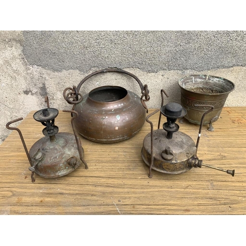 33 - Two brass Primus stoves and a copper pot.