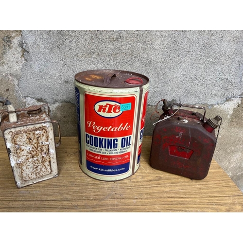 331 - Two petrol cans and a large oil drum. {petrol can 24 cm W x 30 cm H x 17 cm D}