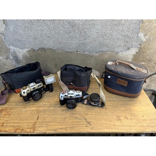 369 - Three vintage Olympia cameras and cases.