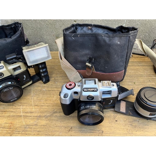 369 - Three vintage Olympia cameras and cases.