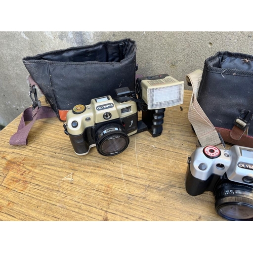 369 - Three vintage Olympia cameras and cases.