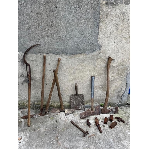 533 - Collection of scythes, axes, shovels and hammer heads.