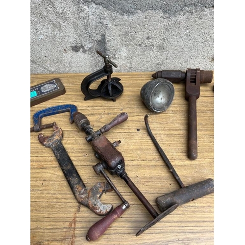 535 - Collection of items including clamps, grinding stone and drill.