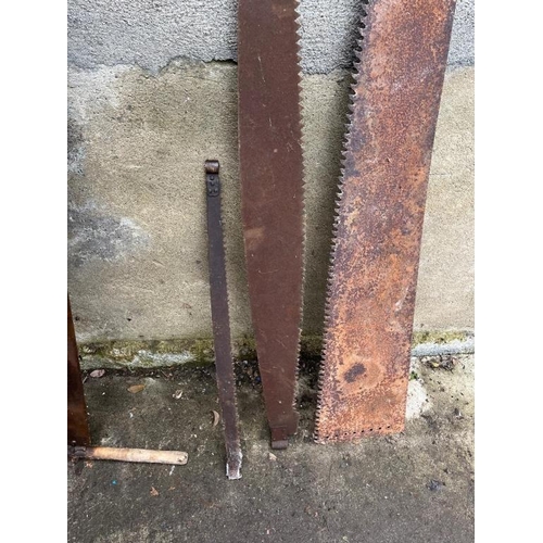 601 - Three crosscut saws and a Pitman saw. {Pitman 167 cm Long}