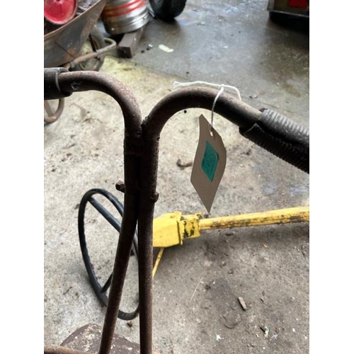 787 - Old garden roller and an old steering wheel on stand.