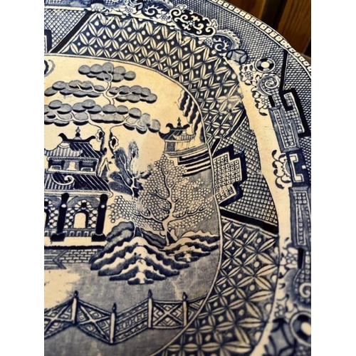 920 - Willow pattern platter with well. {43 cm W x 34 cm H}