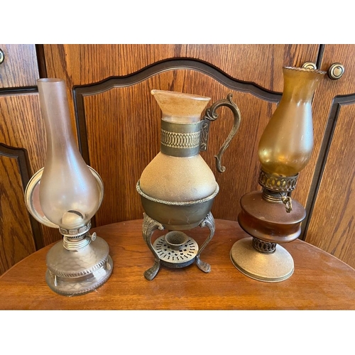 925a - Two vintage oil lamps and a spirit jug.