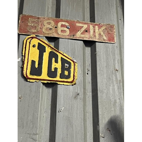 939 - JCB sign and a vintage car number plate. 586 ZIK