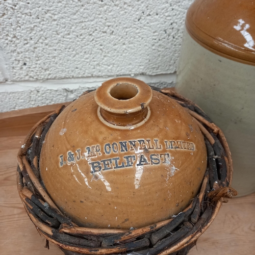 7 - Three old Stoneware Whiskey Jars including O'Connell of Belfast in Wicker Basket