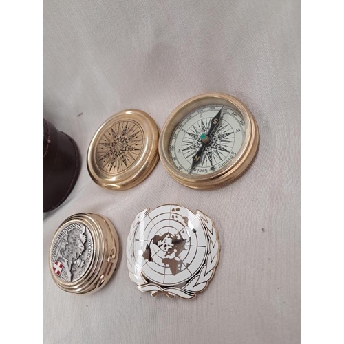 444 - Cased Brass Compass, United Nations Cap Badge and a Pill Box