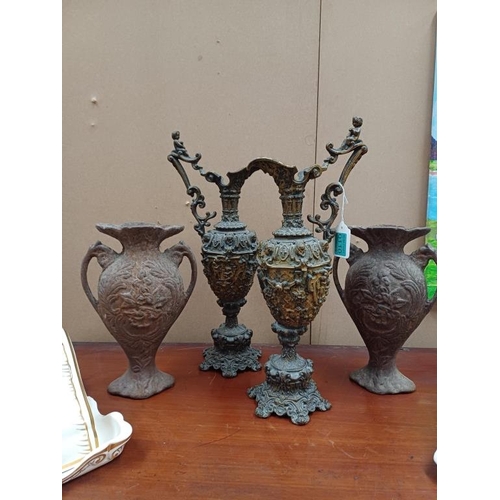 110 - Pair of Metal Claret Jug Vases and a Pair of Cast Iron Vases