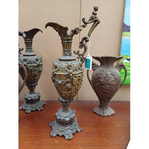 110 - Pair of Metal Claret Jug Vases and a Pair of Cast Iron Vases