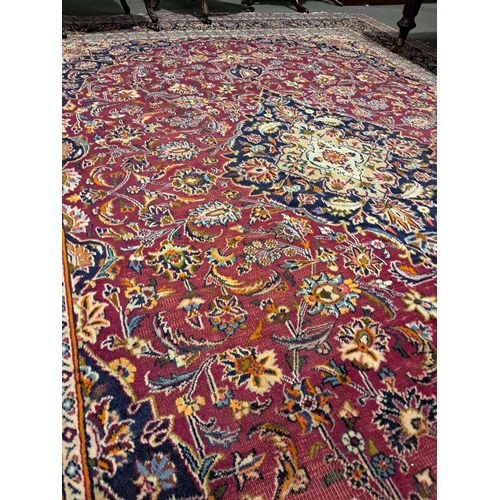 202 - Persian Handwoven Red Ground Carpet of Traditional Medallion Pattern Design (343cm x 245cm)