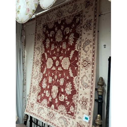 24 - Ivory Ground Rug with Red Ground and Floral Decoration (180cm x 130cm)