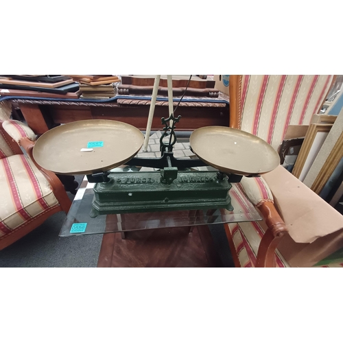 557 - Vintage Weighing Scales with Brass Pans on Cast Iron Base