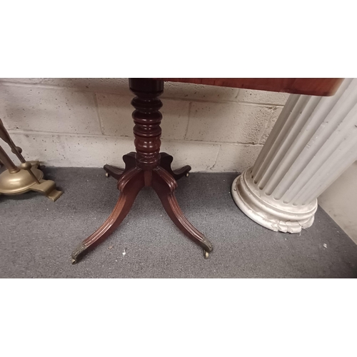 686 - Early 19th Century Mahogany Tea Table on turned column with 4 splay legs on brass castors