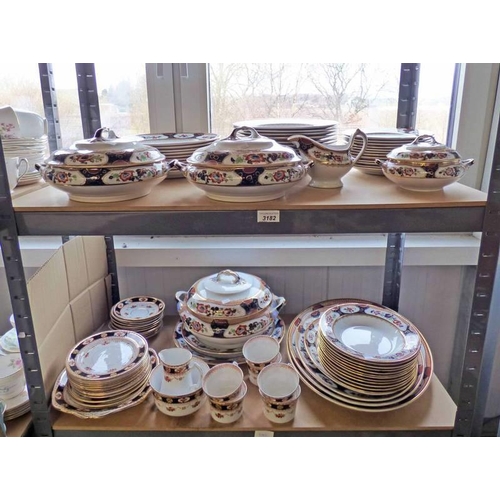 3182 - SELECTION OF PORCELAIN DINNERWARE WITH GILT DECORATION OVER TWO SHELVES