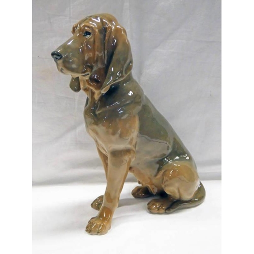 3453 - ROYAL COPENHAGEN PORCELAIN FIGURE OF A BLOODHOUND - NUMBER 1322, 23CM TALL