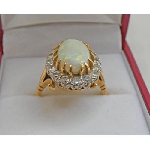 462 - 18CT GOLD OVAL OPAL & DIAMOND SET CLUSTER RING, APPROX 0.8 CARATS IN TOTAL.