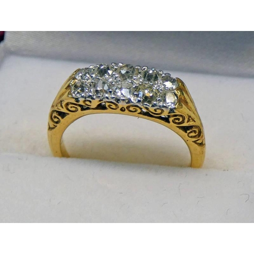 507 - DIAMOND SET 10-STONE RING, THE 2 ROWS OF 5 CUSHION SHAPED DIAMONDS IN A YELLOW METAL SCROLL MOUNT