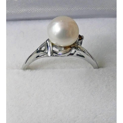 60 - CULTURED PEARL SET RING IN WHITE METAL SETTING MARKED 18K