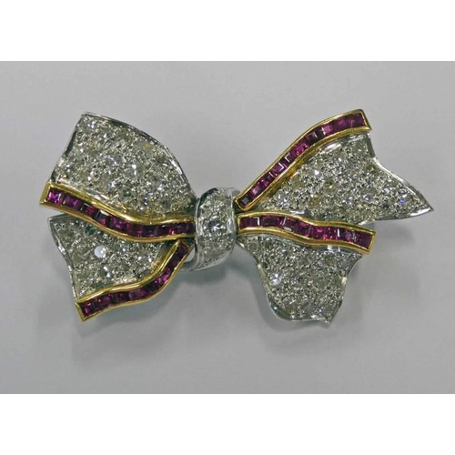 165 - 18CT WHITE GOLD CALIBRE CUT RUBY & DIAMOND RIBBON BOW BROOCH - 4.1 CM WIDE